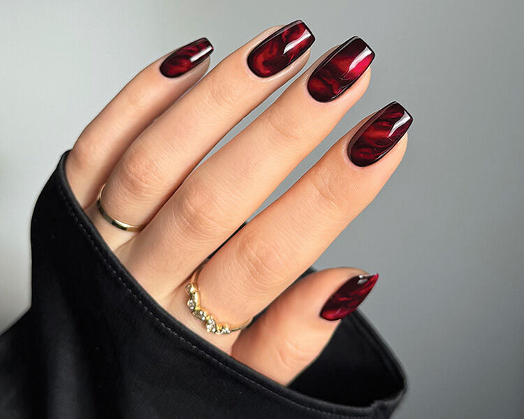 Sarah Haider’s elegant nail design, which she dubbed Runway Red, creates depth by layering various shades of red polish.
