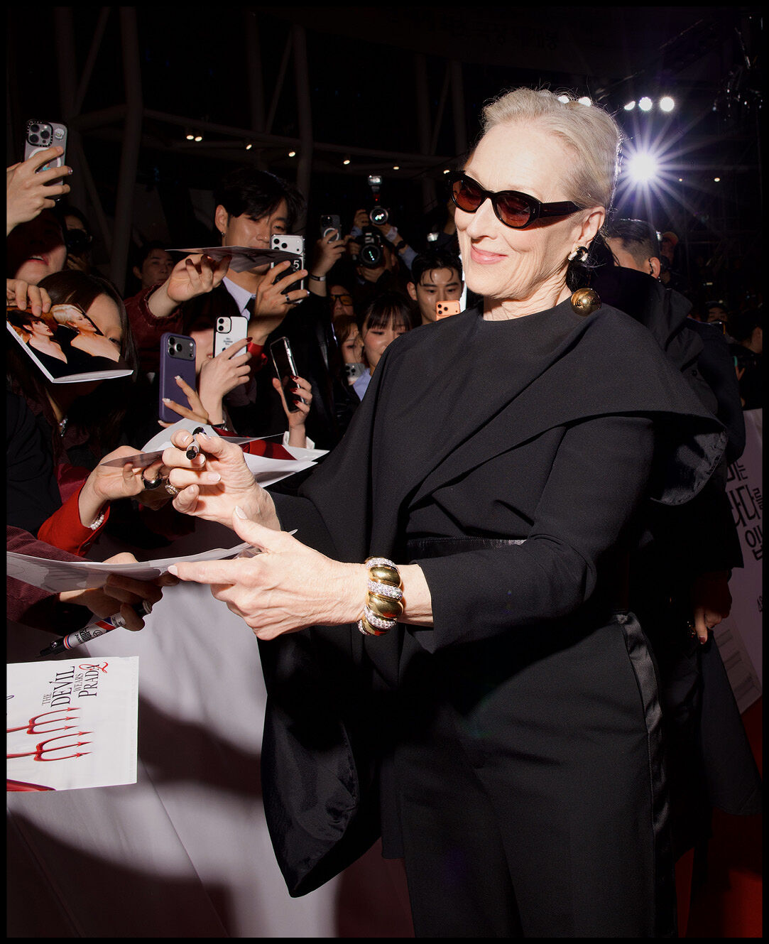 Meryl Streep signs her autograph for fans.
