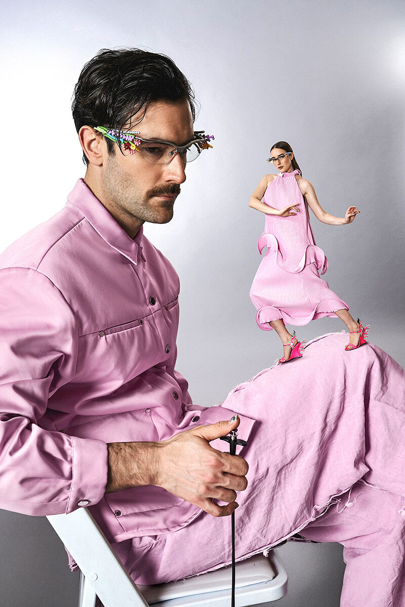 The Young Emperors are pretty in pink while using a visual illusion to make it seem like Isabelle Chaput is dancing on the knee of a seated Nelson Tiberghien.