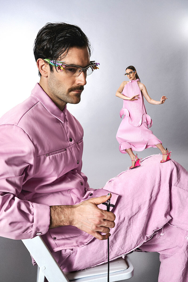 The Young Emperors are pretty in pink while using a visual illusion to make it seem like Isabelle Chaput is dancing on the knee of a seated Nelson Tiberghien.