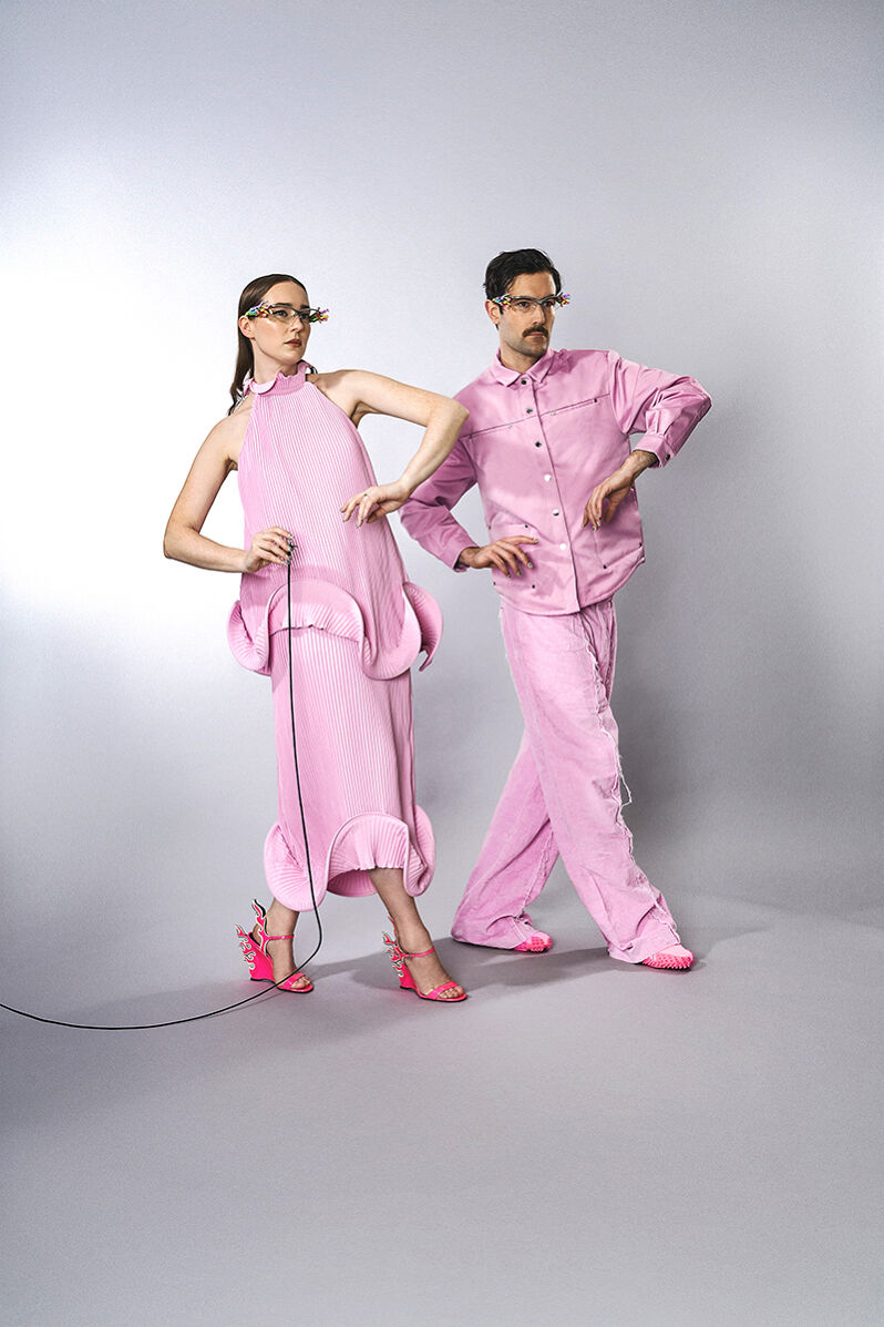 The Young Emperors are in sync in petal pink outfits with matching festive eyeglass frames.