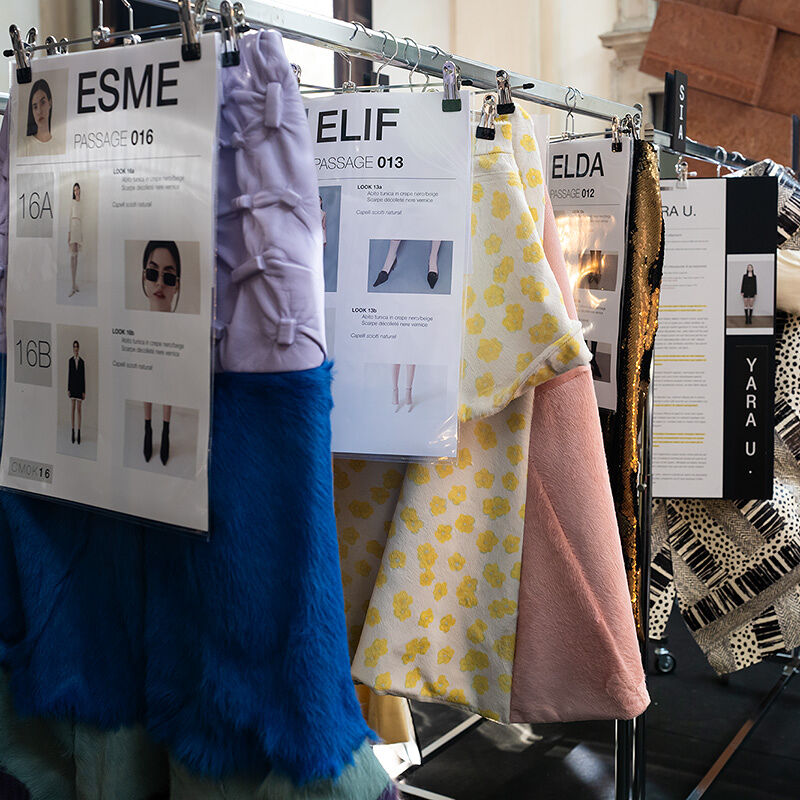 Milan Fashion Week Runway show complete looks hang on the rack before the catwalk chaos begins, each with thorough instructions detailing which model is supposed to wear it, how she is supposed to wear it and with what accessories and hairstyle.