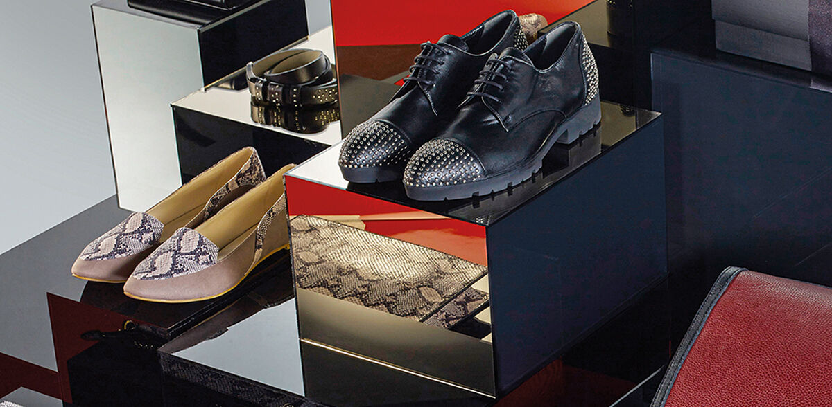 A display featuring updated accessories to add pizazz to your everyday workwear including studded oxfords, reptile print pumps, brightly colored leather, bedazzled belts and wallets and polychromatic purses, which will help you stand out in the office elevator.