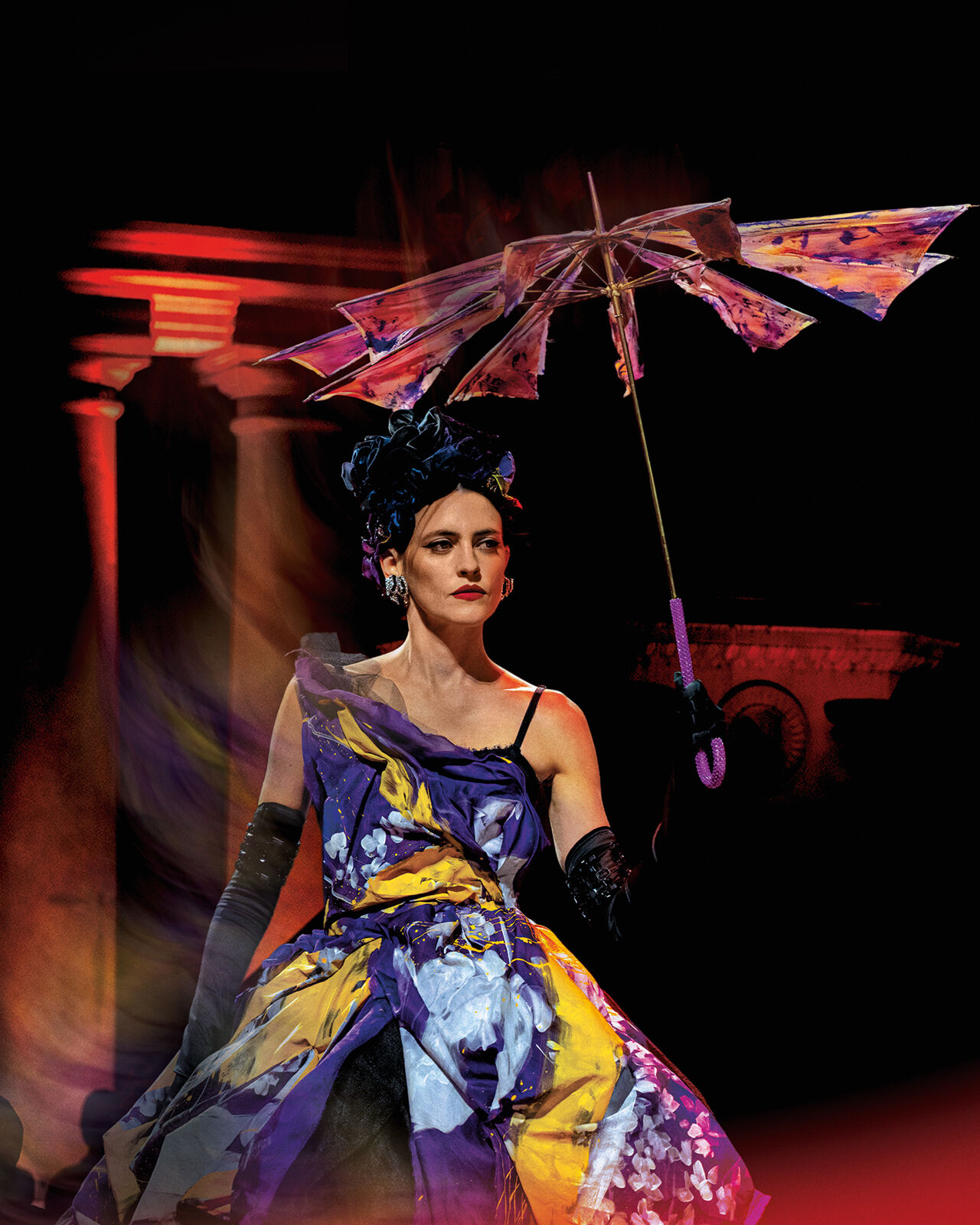A model carries a deconstructed umbrella and wears opera gloves, a head wrap and a seemingly painted asymmetrical gown at Runway magazine’s Milan Fashion Week show.