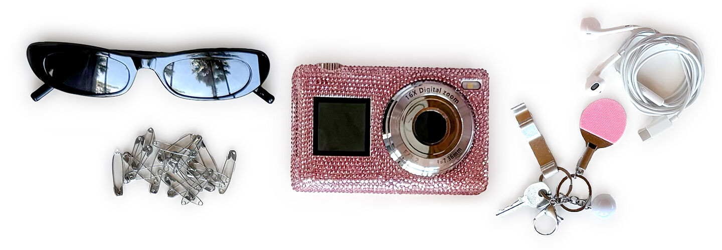 The contents of fashion influencer Malu Borges’ purse, which is shaped like a hair dryer, include sunglasses, hair accessories, a camera, corded earphones, and her often misplaced house keys.