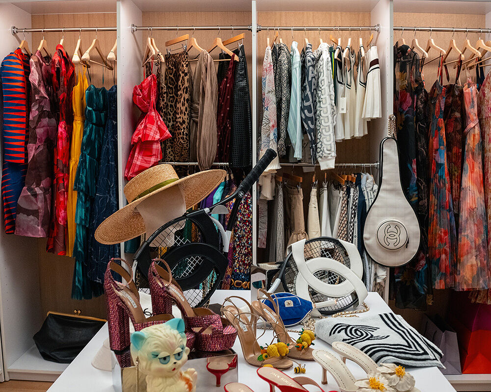 Racks of clothes organized by style and color await the arrival of editor Miranda Priestly but they will have to compete with Chanel’s chic line of tennis accessories and flashy stilettos for her attention.