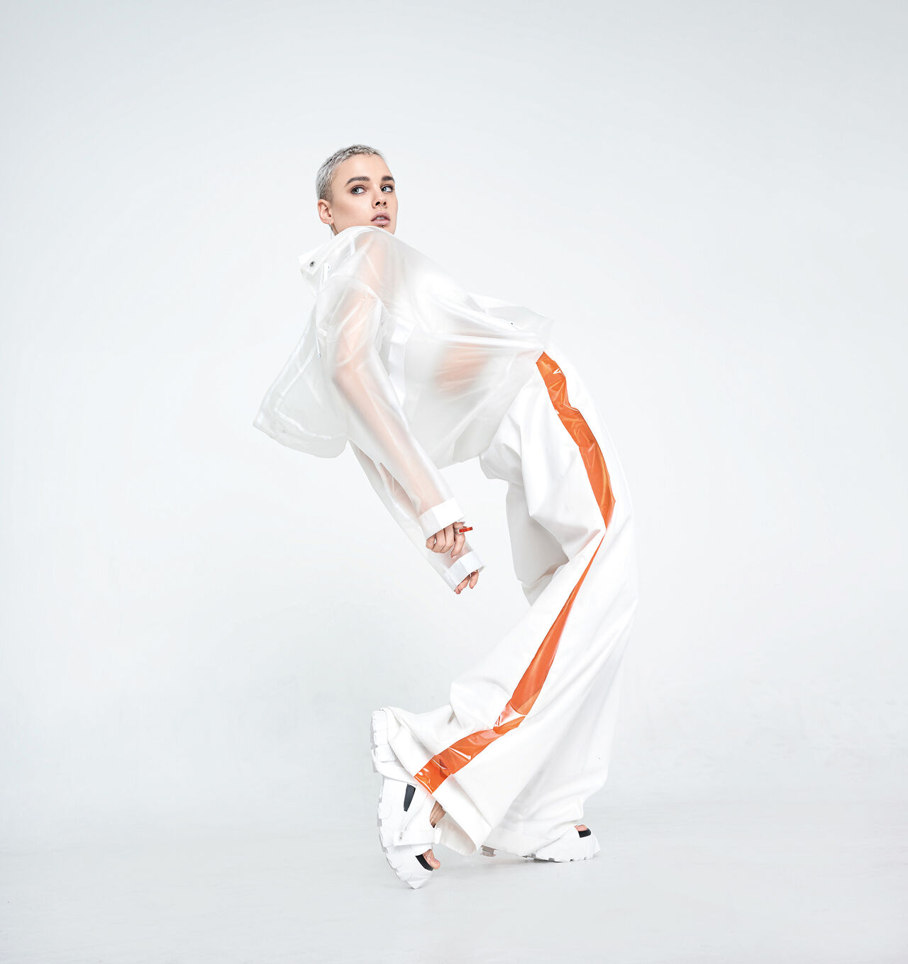 A pale model bends dramatically in a street-smart style that grabs attention despite being mostly monochromatic.