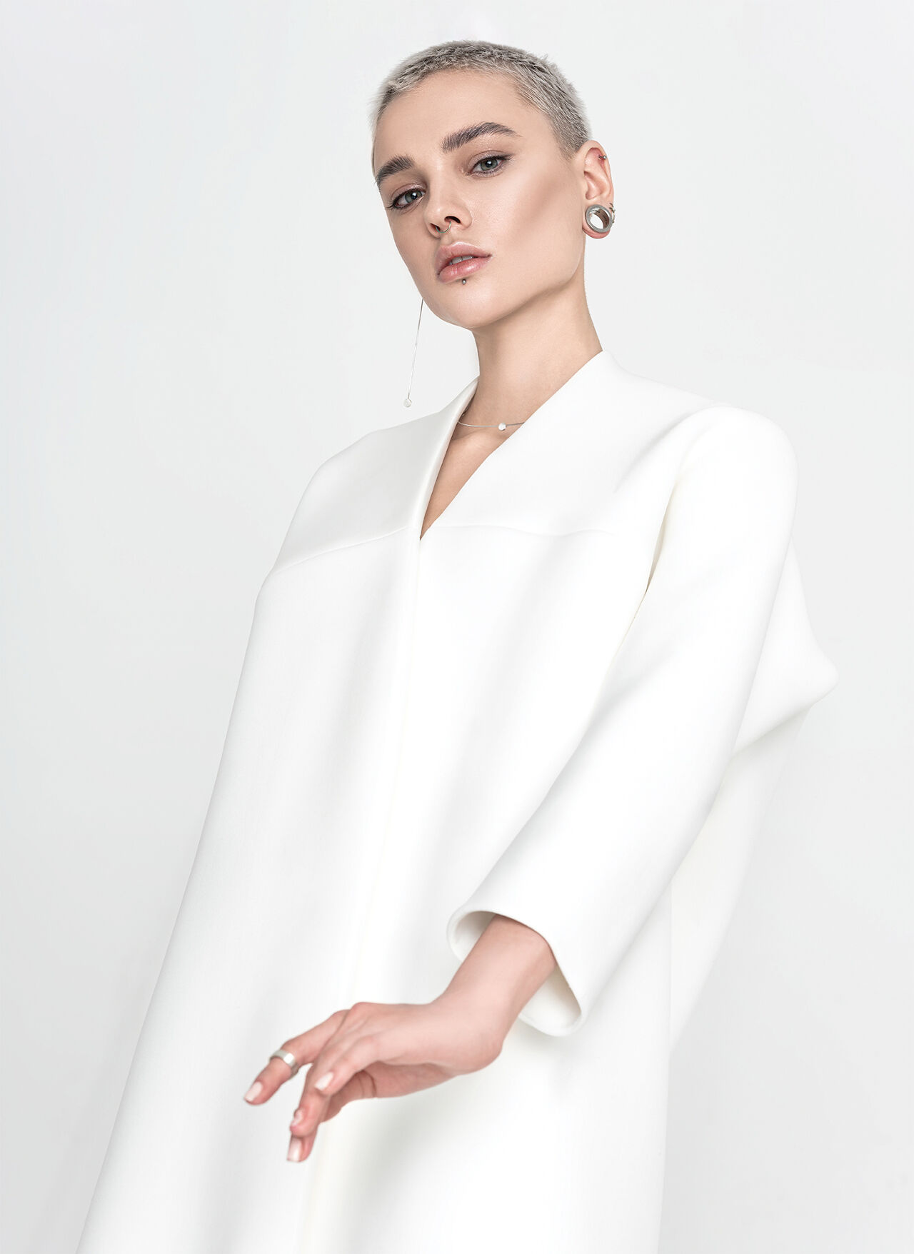 A long-sleeved tunic dress is white hot when paired with minimal silver jewelry and a platinum pixie.