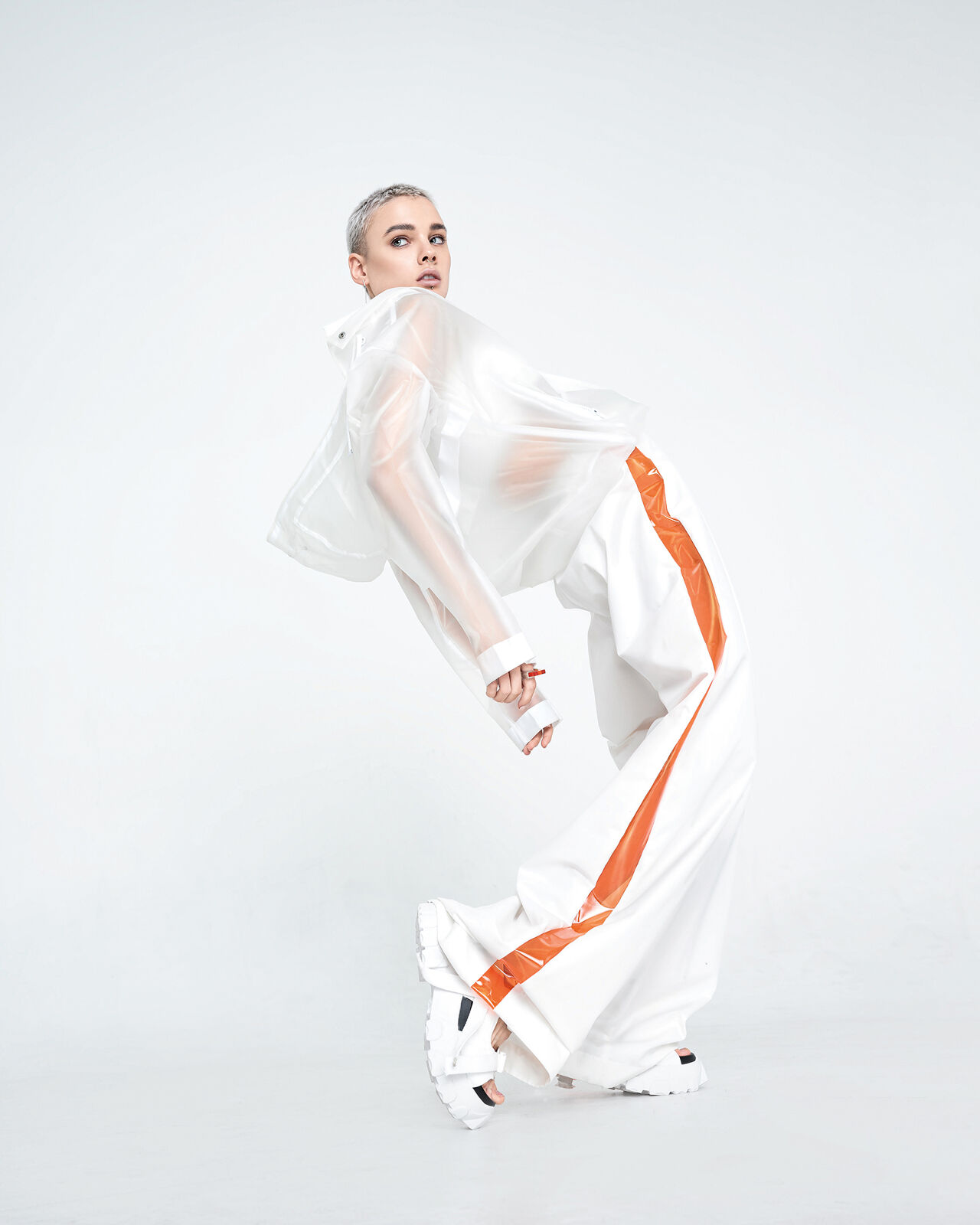 A pale model bends dramatically in a street-smart style that grabs attention despite being mostly monochromatic.