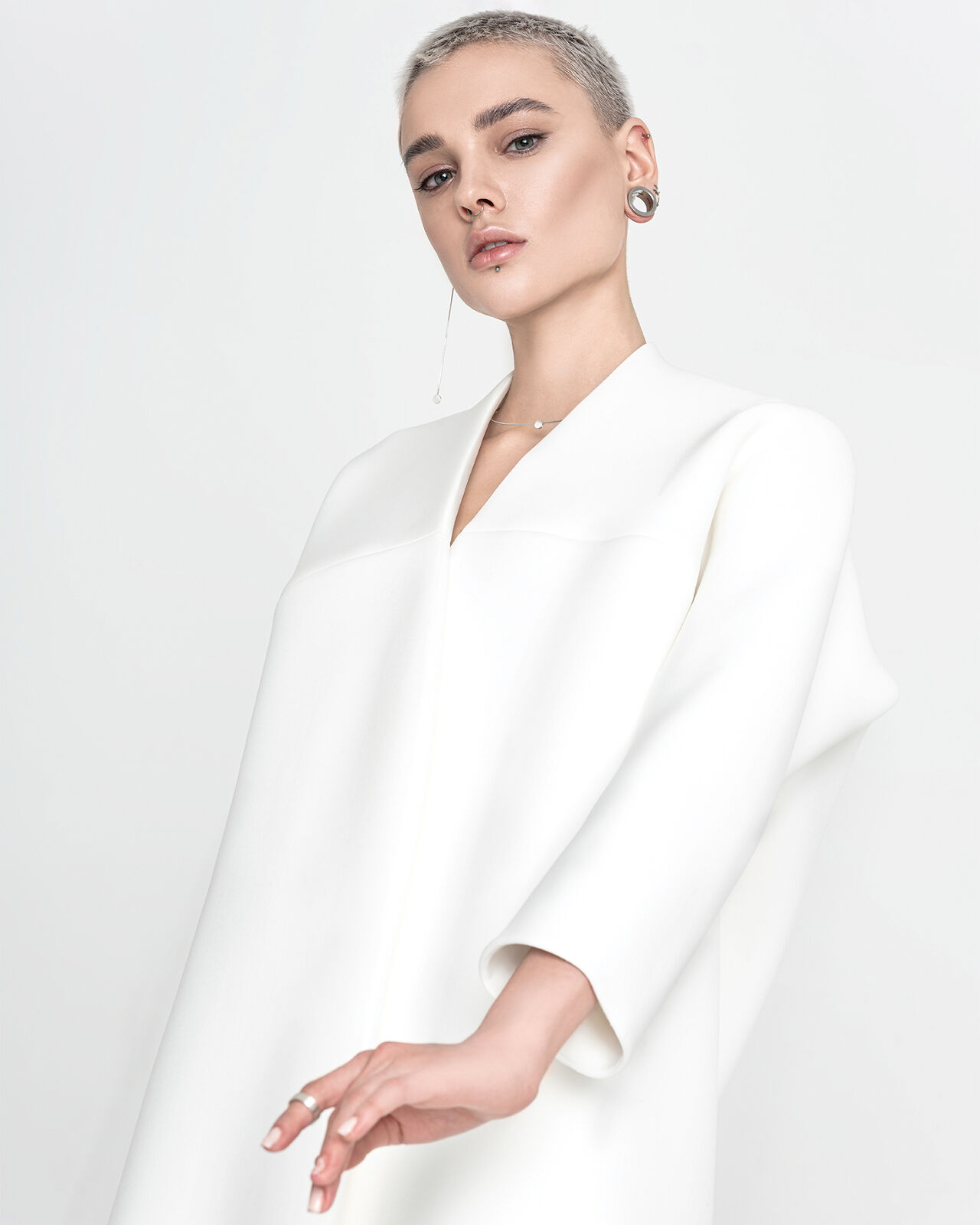 A long-sleeved tunic dress is white hot when paired with minimal silver jewelry and a platinum pixie.