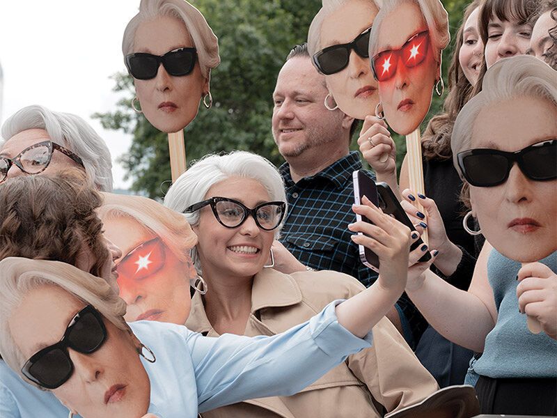 Mask-carrying fans, including a few bespectacled lookalikes, line up hours before the Runway Gala is set to begin in hopes of fashion icon Miranda Priestly.