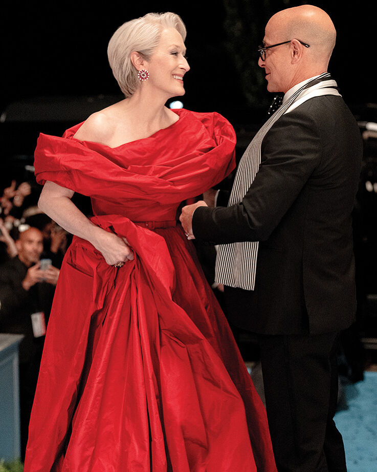 Nigel Kipling, deputy editor of Runway, welcomes his boss Miranda Priestly, the event’s host, and her devilishly glamorous red-hot gown to the cerulean carpet at the annual Runway Gala.