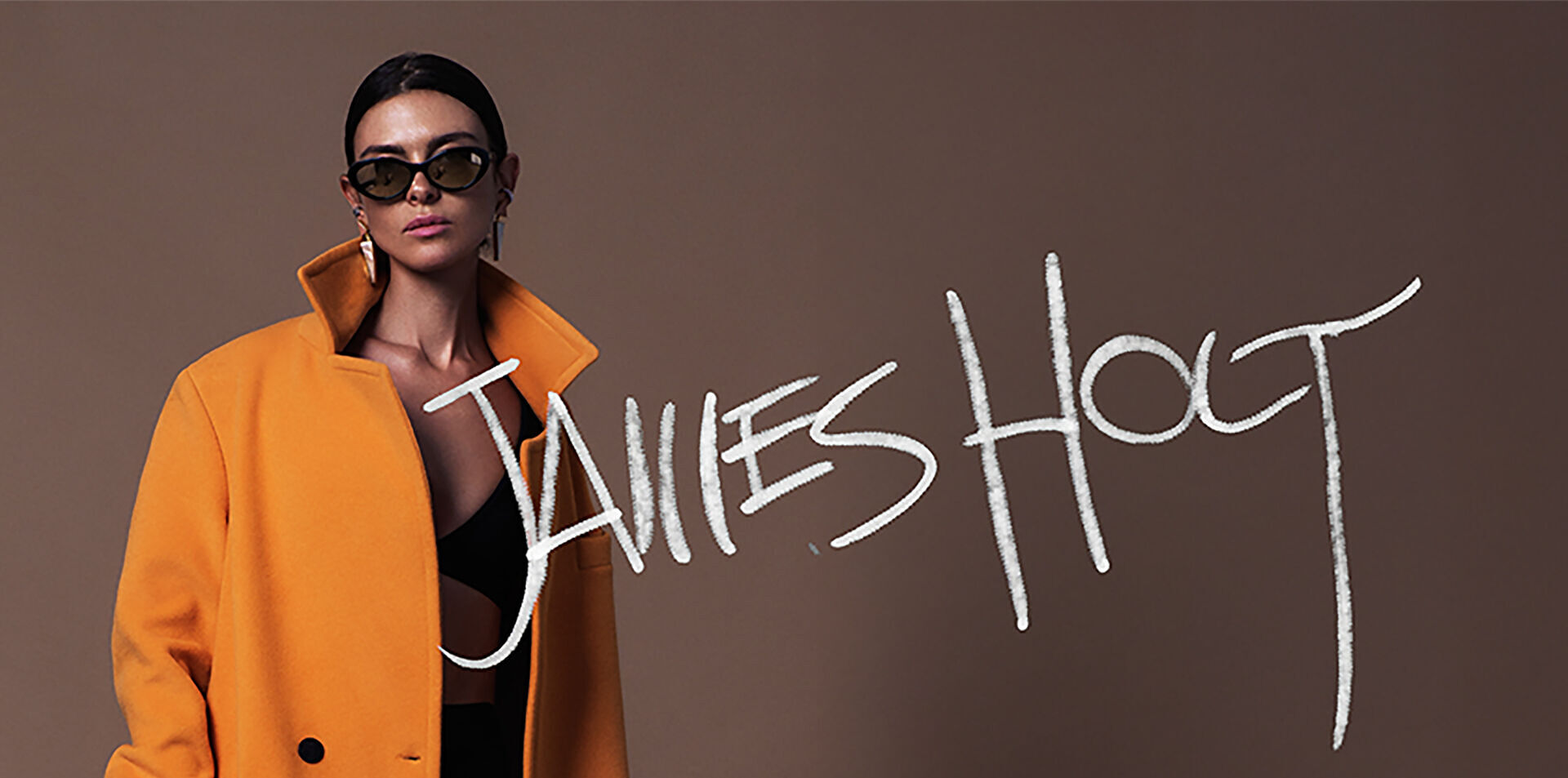 A model sports a floor-length goldenrod bespoke jacket from the new outerwear line JH by designer James Holt, who returned to fashion after selling his successful global brand and a sabbatical spent mountaineering in Europe.