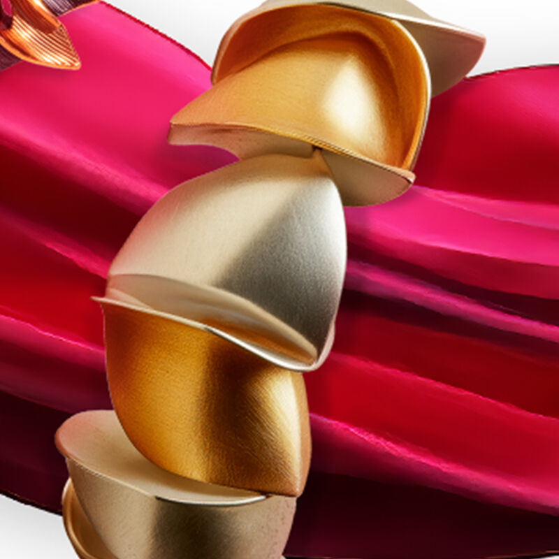 Silver and gold is combined to create a striking ring and sculptural bracelet stack displayed on a ribbon of red fabric.