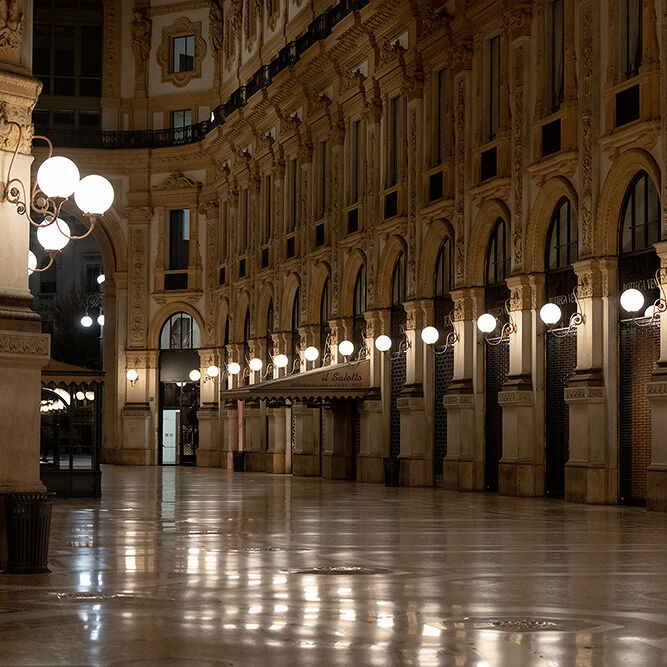 At night, the halls of Milan’s Galleria Vittorio Emanuele II, Italy’s oldest active shopping arcade are quiet and lit by globe scones. But by day, the four-story landmark named after the first king of Italy buzzes with shoppers and sightseers admiring its massive glass dome, mosaic floors and luxury boutiques.